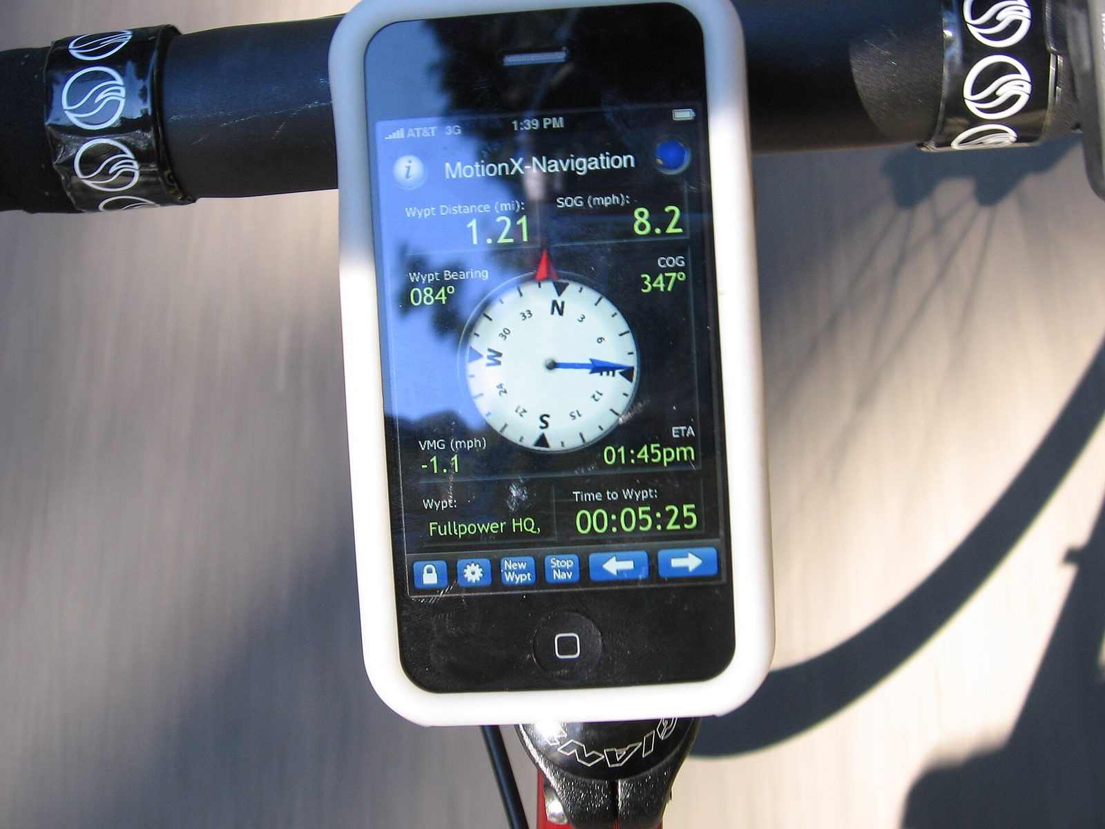 iPhone mounted on bicycle handlebars running a GPS navigation app