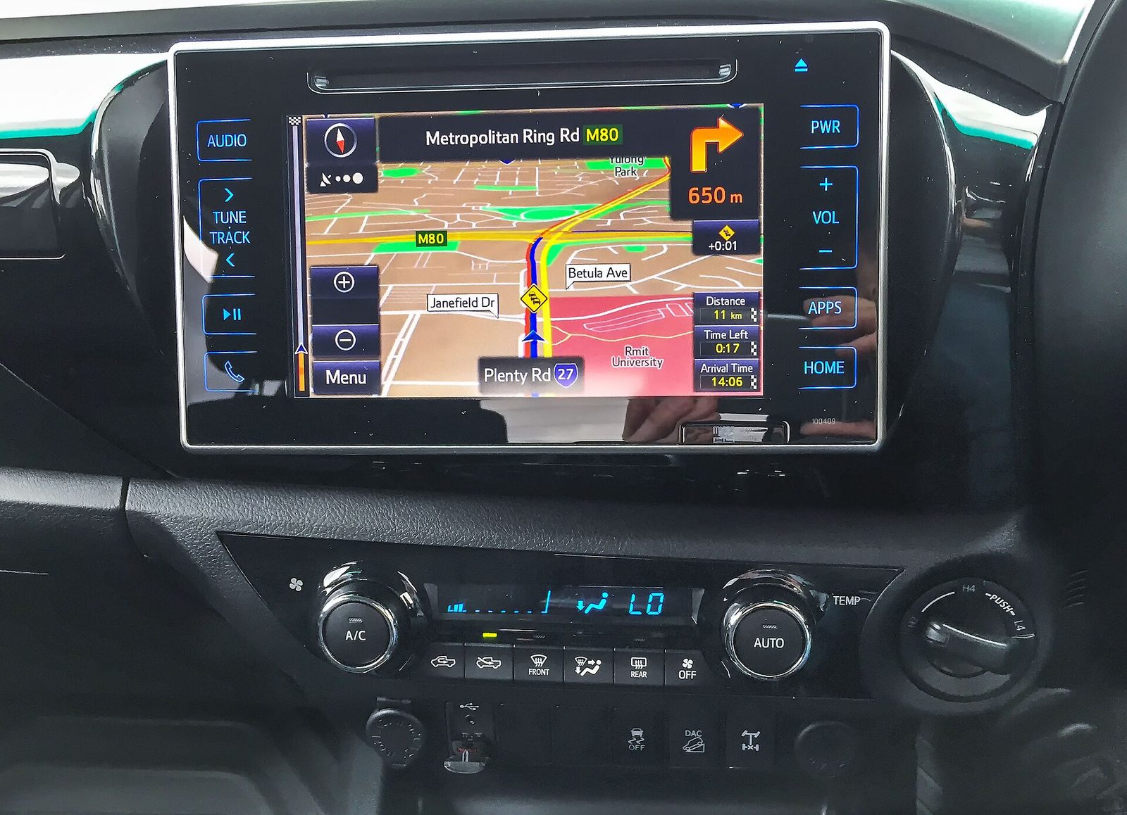 In-dash car sat nav screen showing a route map on the dashboard