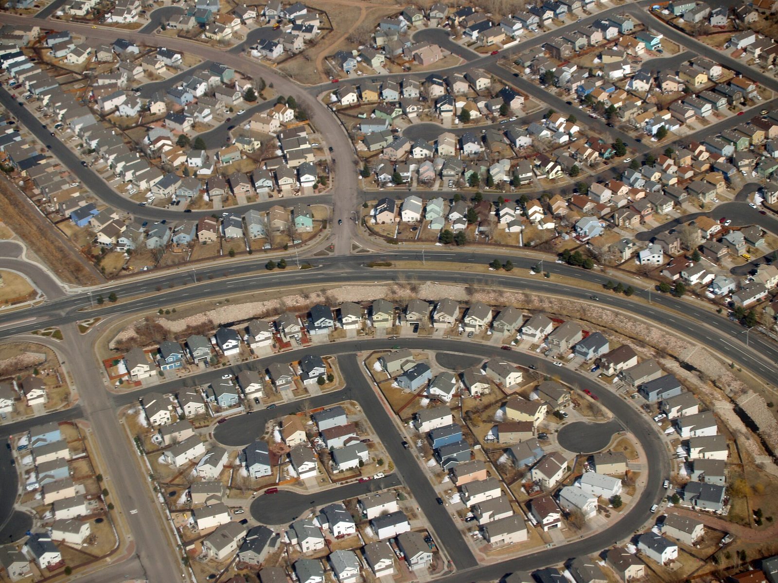 Aerial view of a dense suburban neighbourhood grid of houses and streets