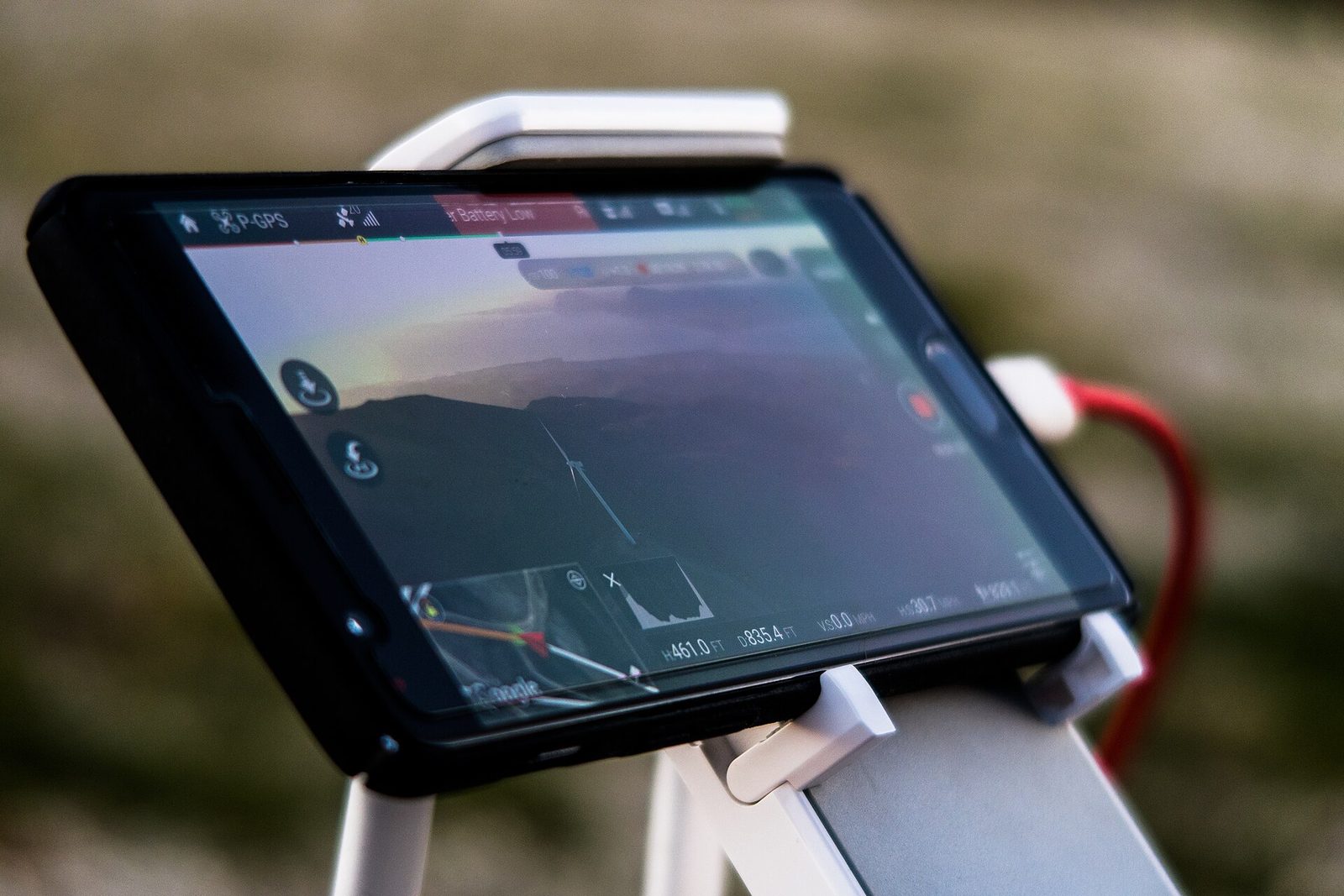 Smartphone in an outdoor mount showing a map with the current position